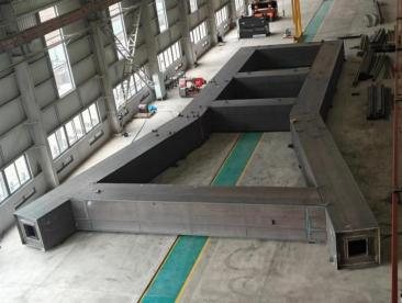 Full-scale trial assembly of a fabricated steel frame on the workshop floor