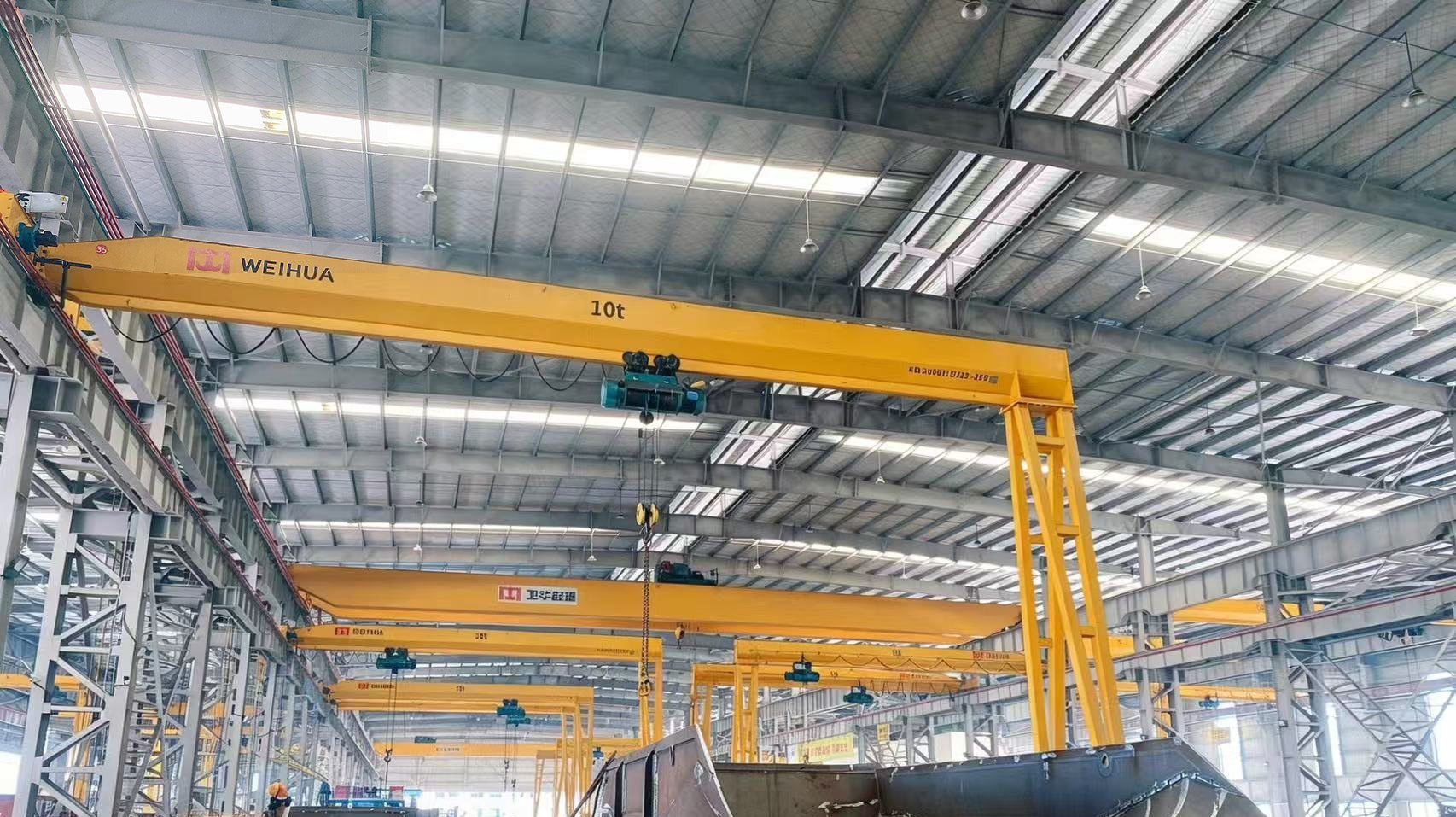 Overhead crane lifting a bundle of fabricated welded H-beams