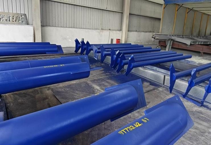 Painted tubular steel assemblies staged in the workshop