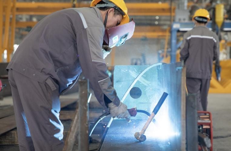 Welder working on a fabricated steel component in the workshop