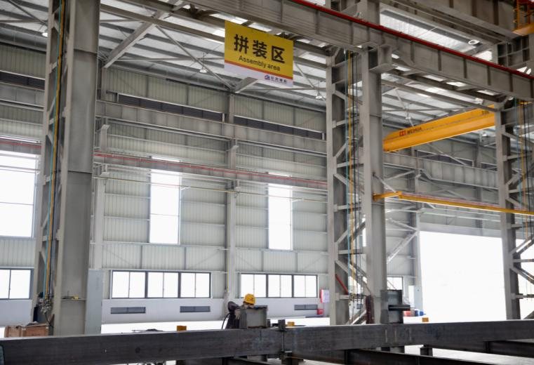 Fabricated steel members staged in the bay before dispatch