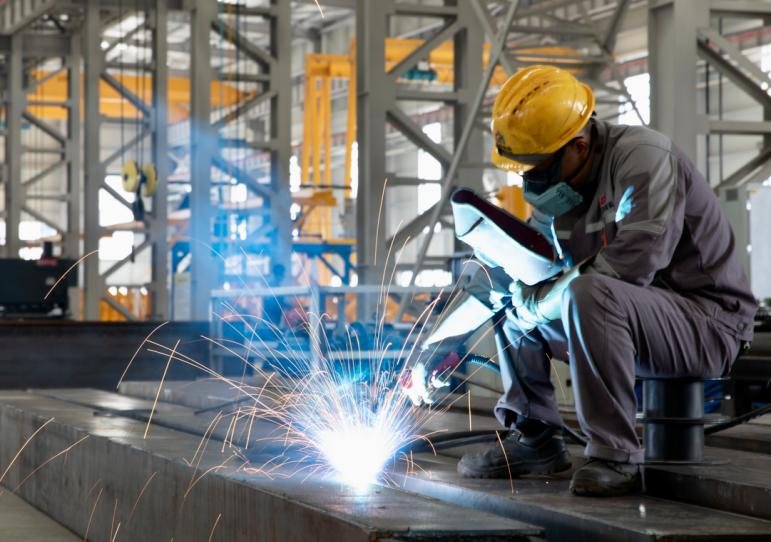 Welder producing a full-penetration weld on a fabricated steel member