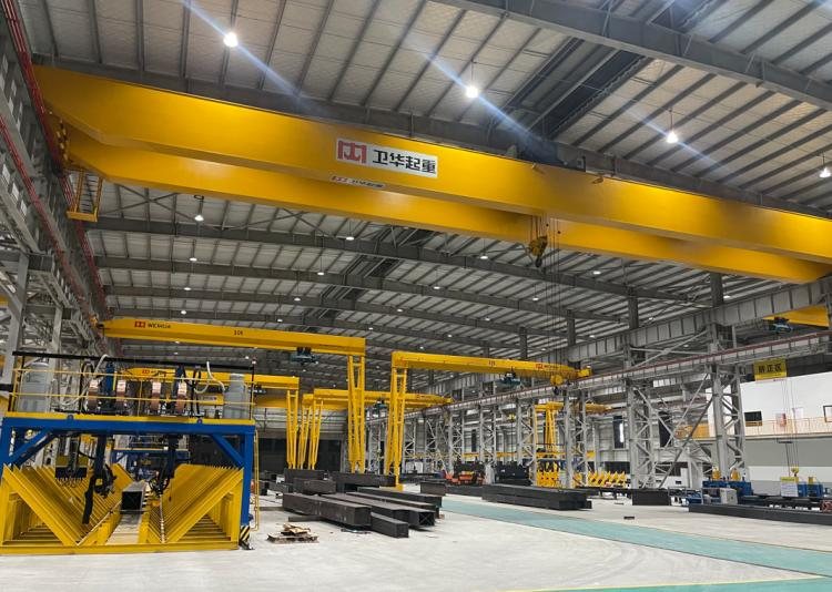 Production bay with fabricated H-beams staged on racks