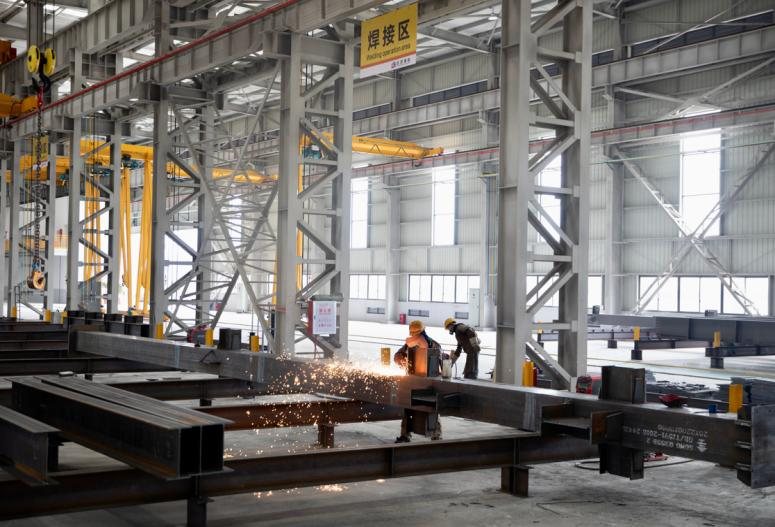 Fit-up and assembly area with operators preparing steel members